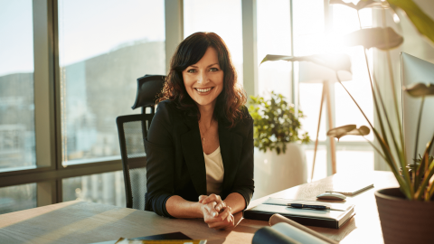 A professional woman behind a desk to represent different types of lawyers in South Africa.